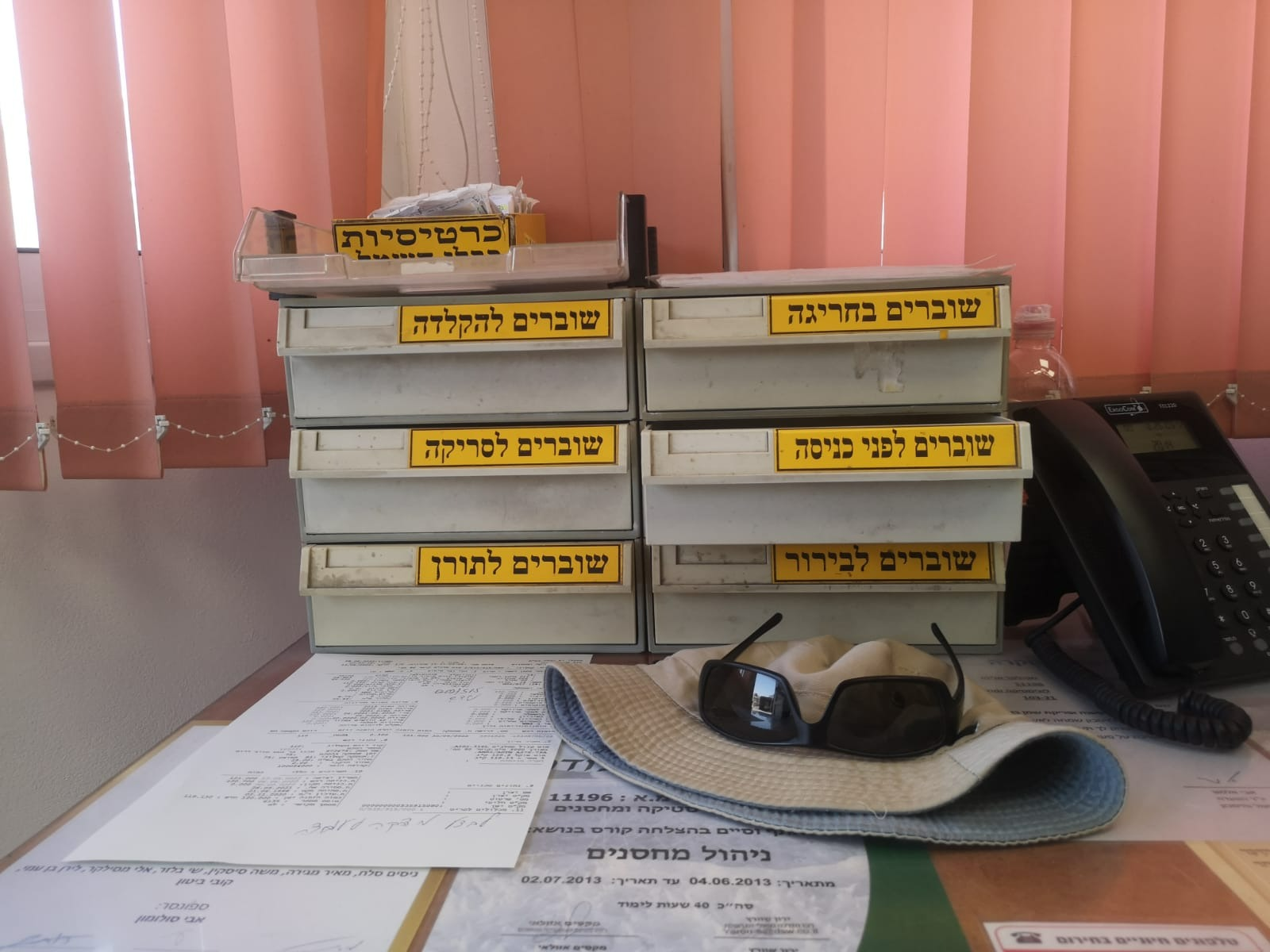 A warehouse office with compartments labeled for different paper categories — an entire filing system built around the paper-based dispatch process